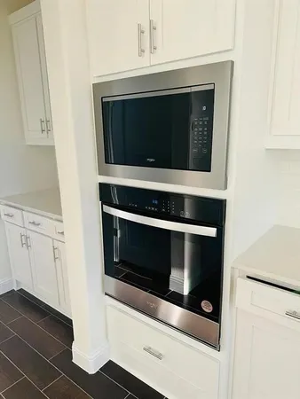 a stove top oven sitting inside of a kitchen