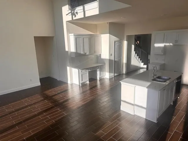 a view of a livingroom with wooden floor and a flat screen tv