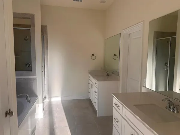 a bathroom with a bathtub and a shower