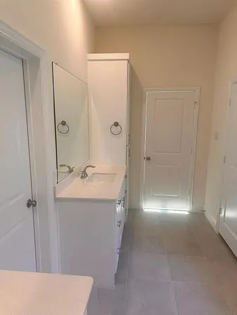 a bathroom with a sink and mirror with shower