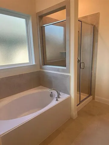 a bathroom with a bathtub and shower
