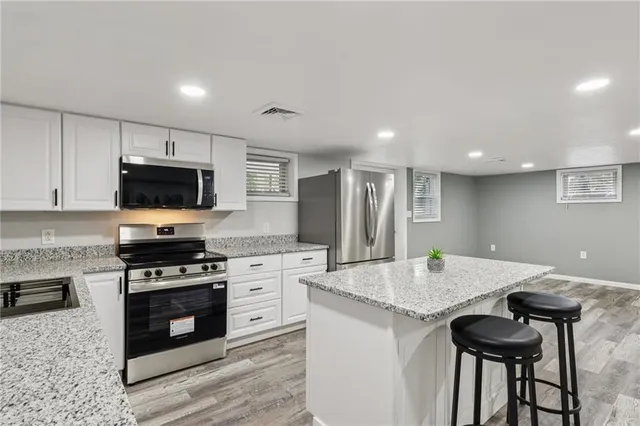 a kitchen with granite countertop a stove and a sink