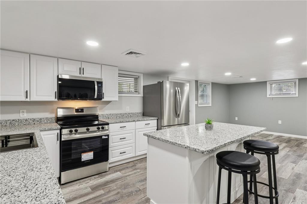 305 Queenstown Road Karns City, PA 16041 - Photo 18 of 38 a kitchen with granite countertop a stove and a sink