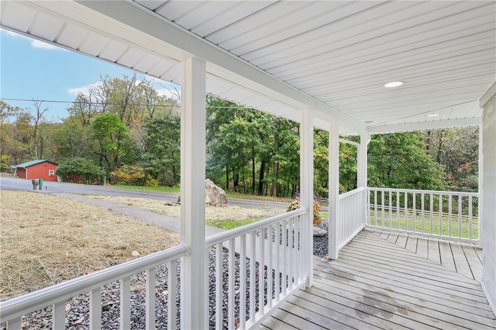 305 Queenstown Road Karns City, PA 16041 - Photo 5 of 38 a view of a porch with wooden floor next to a yard