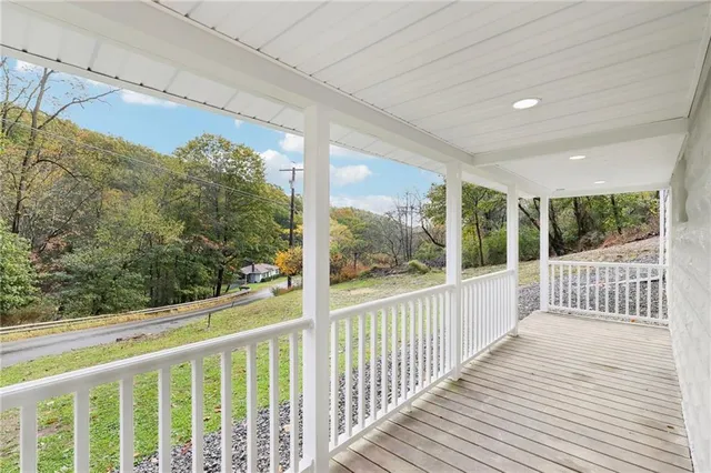 a view of a balcony with wooden floor