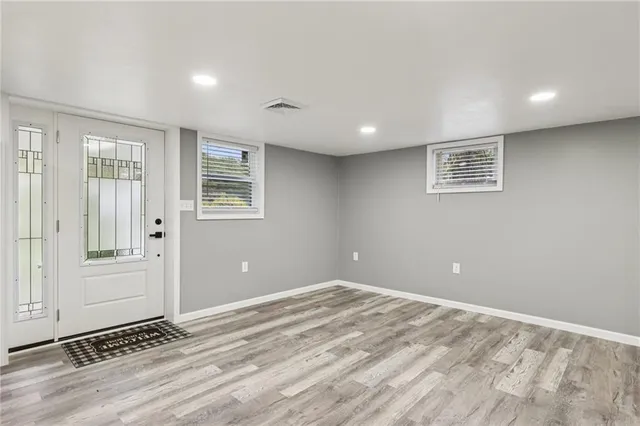 a view of a livingroom with wooden floor and window