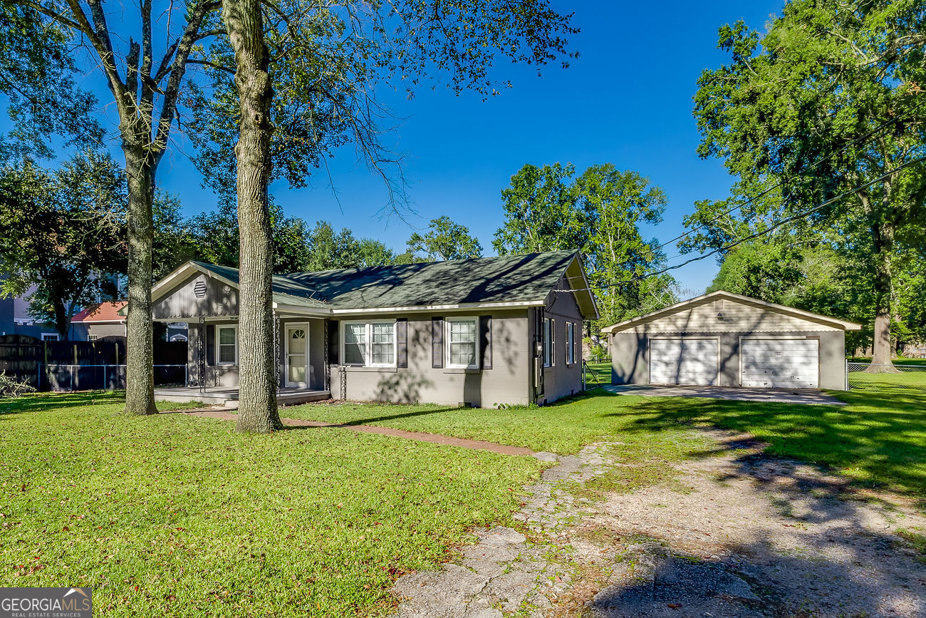 a front view of house with yard and green space