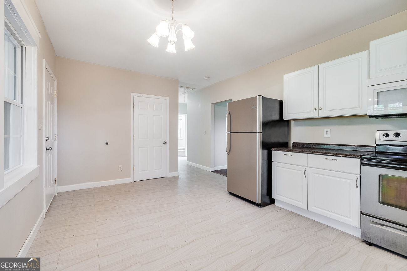 125 Parsons Avenue Pooler, GA 31322 - Photo 12 of 28 a kitchen with a refrigerator and cabinets