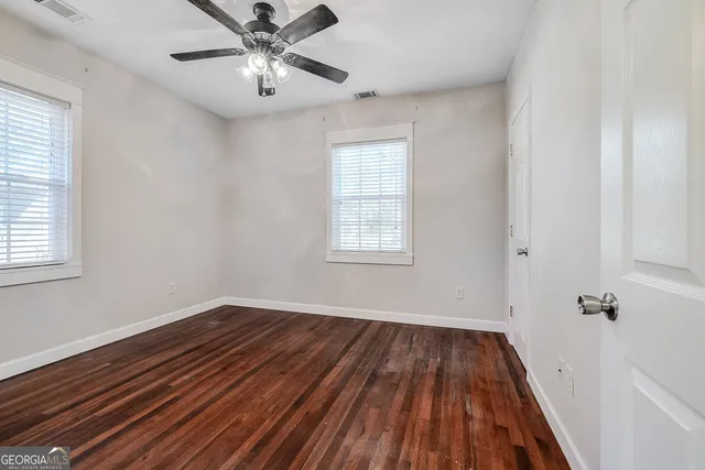 a view of a room with wooden floor and windows