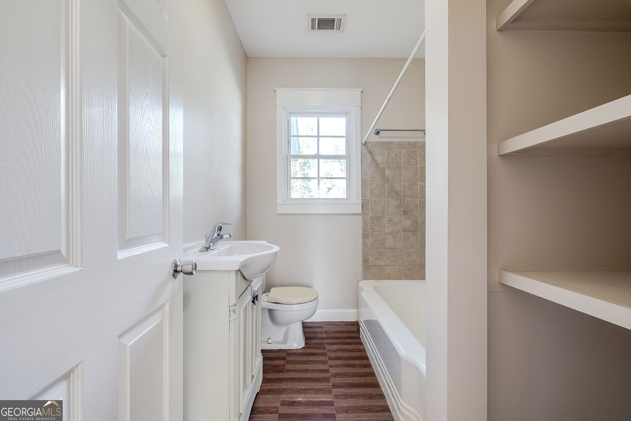 125 Parsons Avenue Pooler, GA 31322 - Photo 18 of 28 a bathroom with a sink a toilet and a window