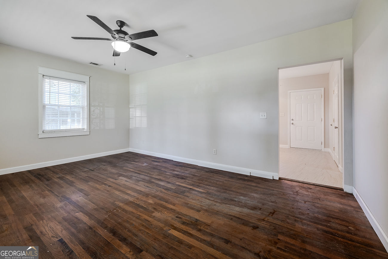 125 Parsons Avenue Pooler, GA 31322 - Photo 5 of 28 an empty room with wooden floor fan and windows