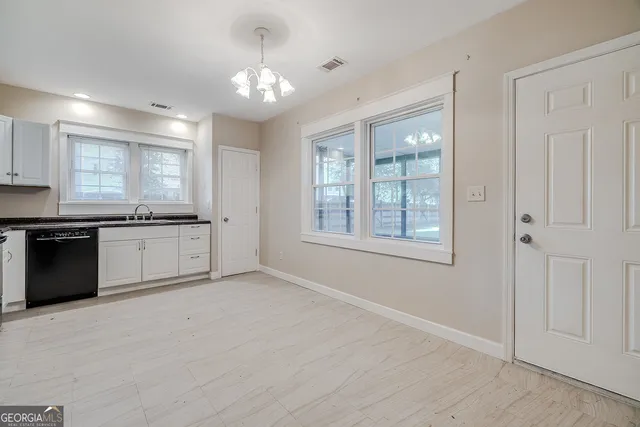 a large kitchen with cabinets and stainless steel appliances