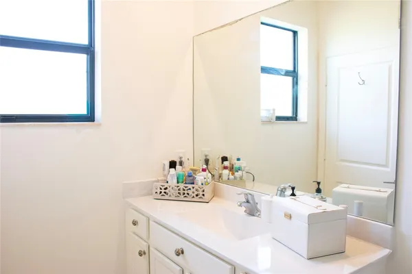 a bathroom with a sink vanity and toilet
