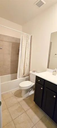 a bedroom with a bed and painting on the wall