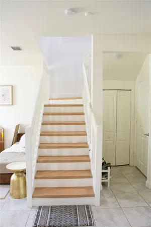 a kitchen with stainless steel appliances a stove a sink a microwave a refrigerator and chairs