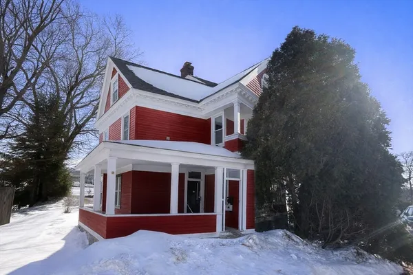a view of a house with a yard and garage