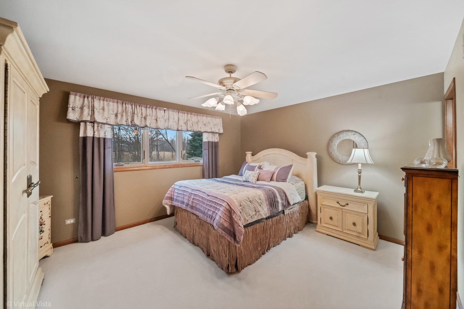 1262 Rutgers Drive Woodridge, IL 60517 - Photo 13 of 22 a bedroom with a large bed and a chandelier