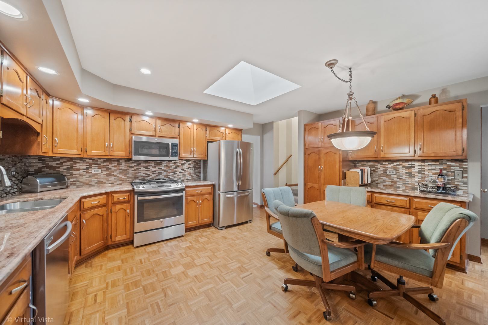 1262 Rutgers Drive Woodridge, IL 60517 - Photo 6 of 22 a kitchen with a table chairs sink and cabinets