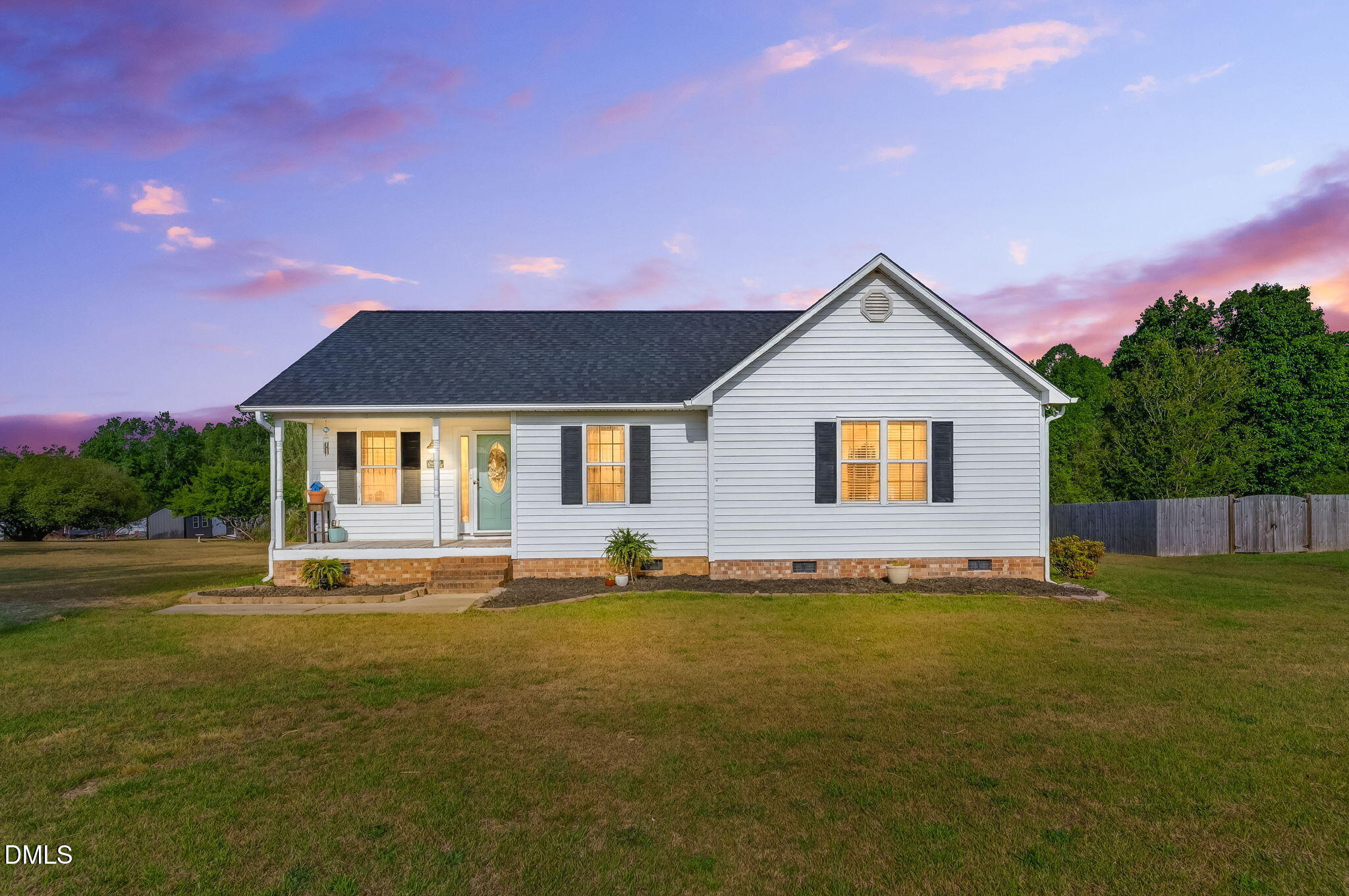 1101 Live Oak Road Coats, NC 27521 - Photo 1 of 29 a front view of house with yard and trees in the background