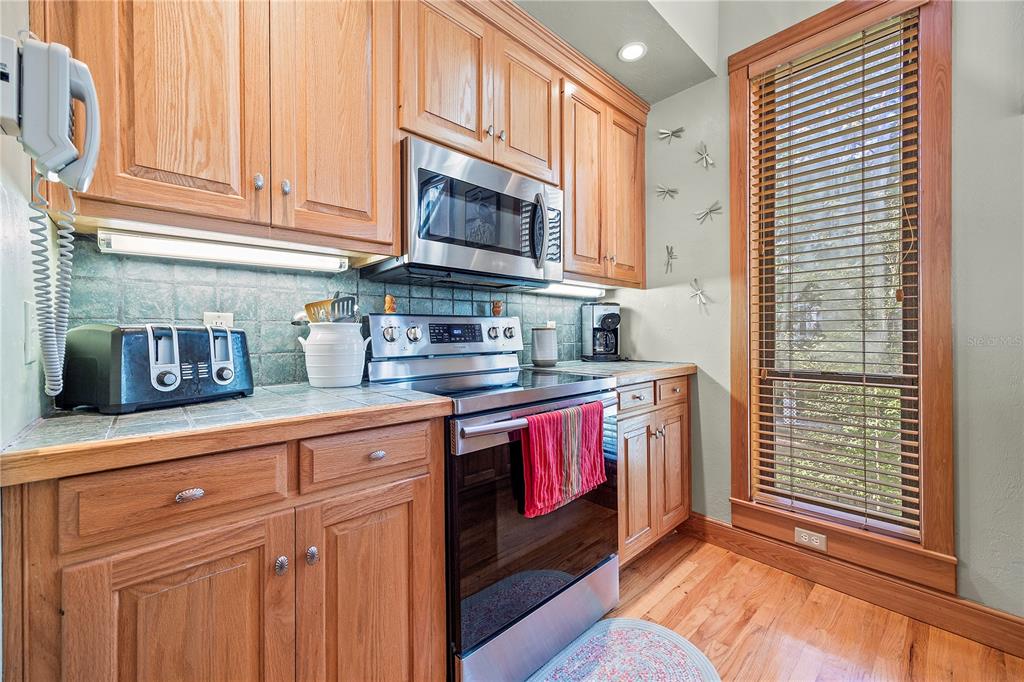 1376 Southwest Riverside Avenue Fort White, FL 32038 - Photo 12 of 40 a kitchen with stainless steel appliances granite countertop a stove a sink and a microwave