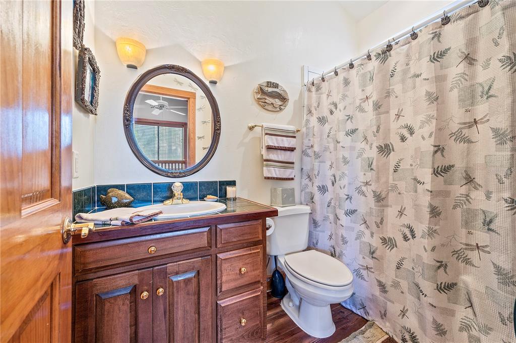 1376 Southwest Riverside Avenue Fort White, FL 32038 - Photo 18 of 40 a bathroom with a toilet a sink and a mirror