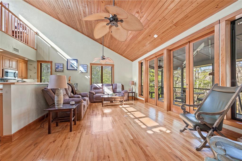 1376 Southwest Riverside Avenue Fort White, FL 32038 - Photo 6 of 40 a living room with furniture a wooden floor and a chandelier