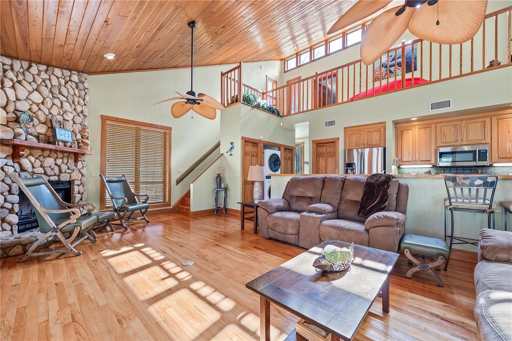 1376 Southwest Riverside Avenue Fort White, FL 32038 - Photo 7 of 40 a living room with furniture a fireplace and wooden floor