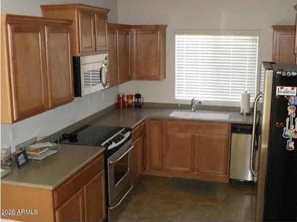 a kitchen with granite countertop a sink and a stove