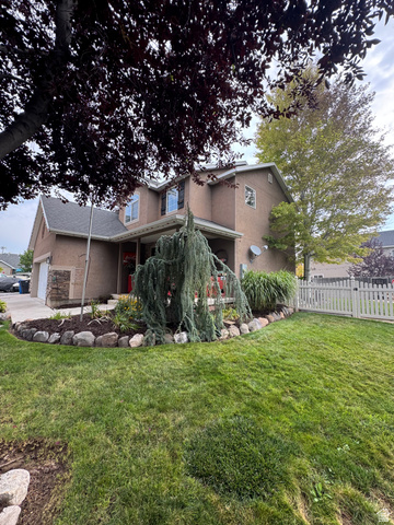 1237 South 260 West Payson, UT 84651 - Photo 5 of 81 Two-story stucco exterior with a gabled roofline, stone facade accents, a front porch, and a fenced front yard