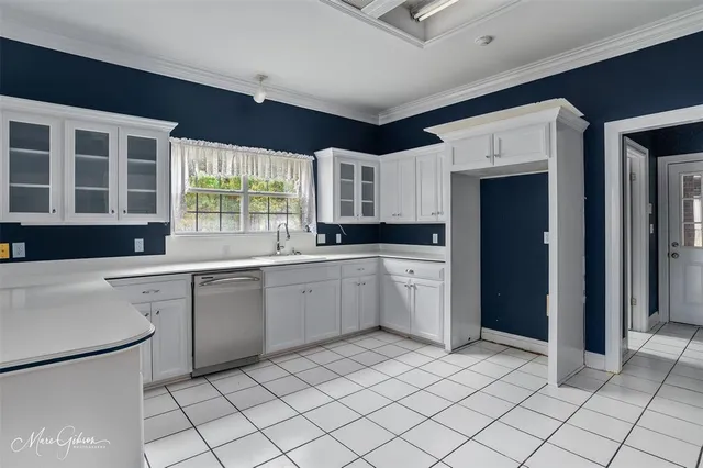 a kitchen with a sink window and cabinets