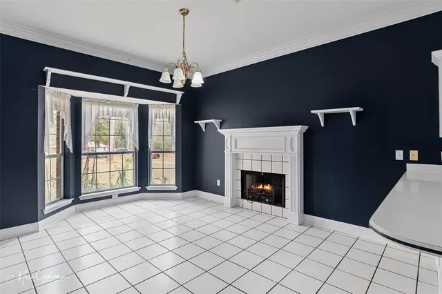a view of an empty room with a fireplace and a window