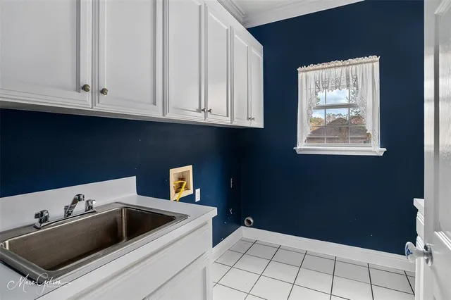 a kitchen with white cabinets and a sink