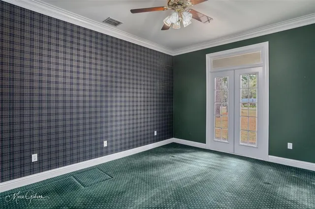 a view of an empty room with a chandelier