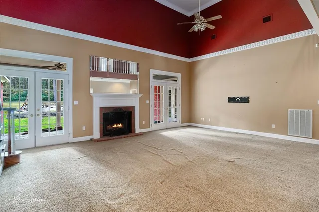 a view of an empty room with a fireplace and a window