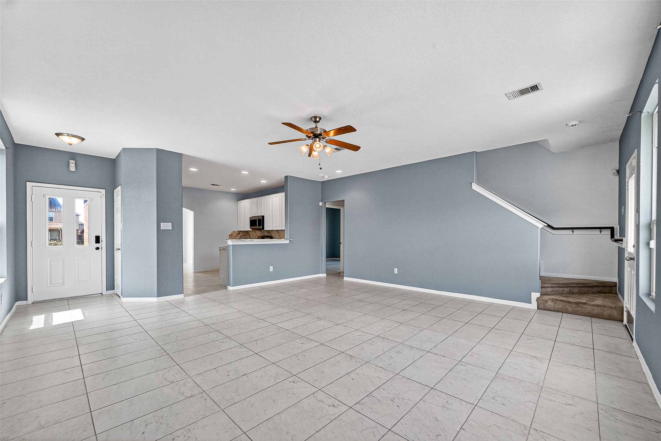 2702 Modano Court Fresno, TX 77545 - Photo 6 of 46 a view of a kitchen with cabinet and a chandelier fan