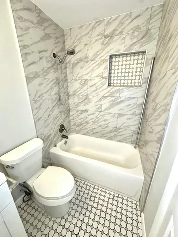 a bathroom with a toilet a sink and a bathtub