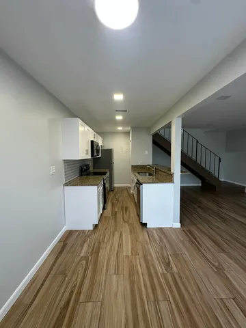 a view of kitchen with sink and microwave