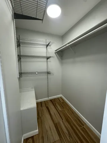 a view of a room with wooden floor