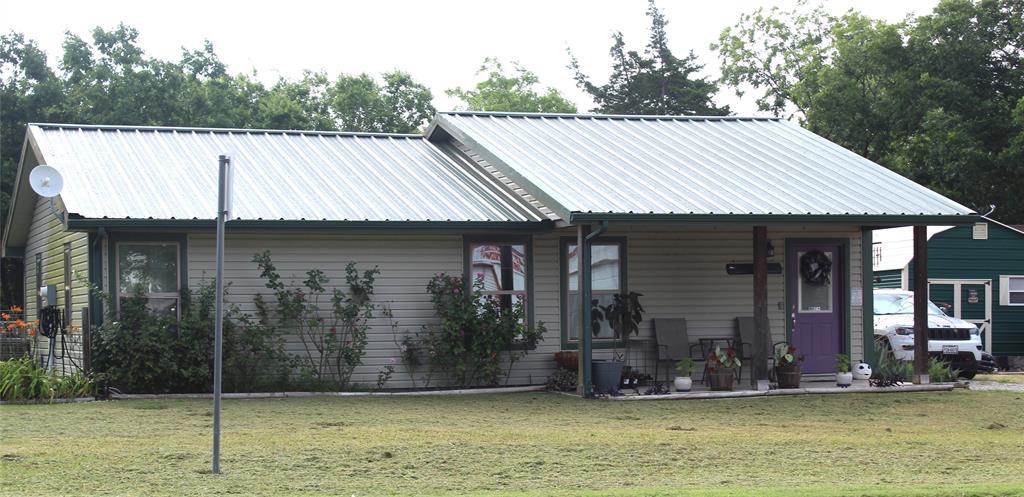 402 Cleveland Street Bailey, TX 75452 - Photo 1 of 17 View of front of house with a front lawn, a metal roof, and a porch