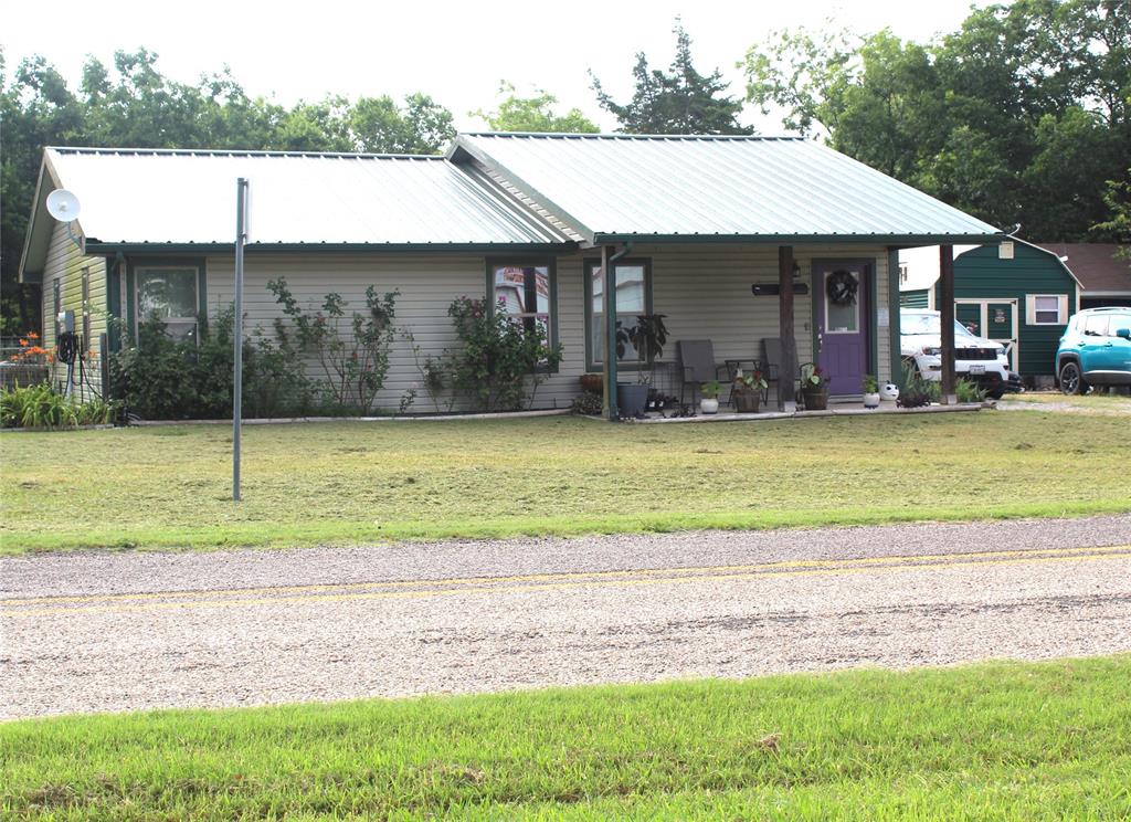 402 Cleveland Street Bailey, TX 75452 - Photo 2 of 17 View of front of house featuring a front lawn, covered porch, and a metal roof