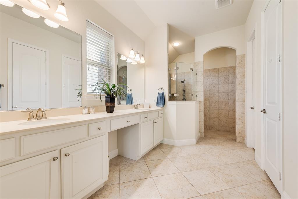 14026 Gutierrez Road Frisco, TX 75035 - Photo 16 of 36 a bathroom with a double vanity sink mirror and shower