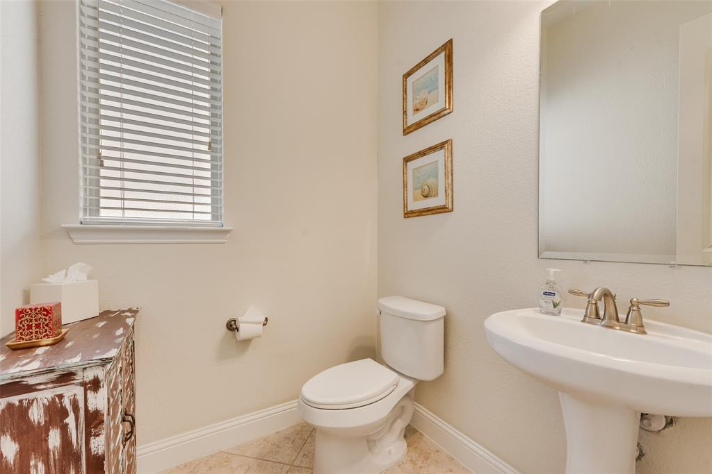 14026 Gutierrez Road Frisco, TX 75035 - Photo 25 of 36 a bathroom with a toilet sink and mirror
