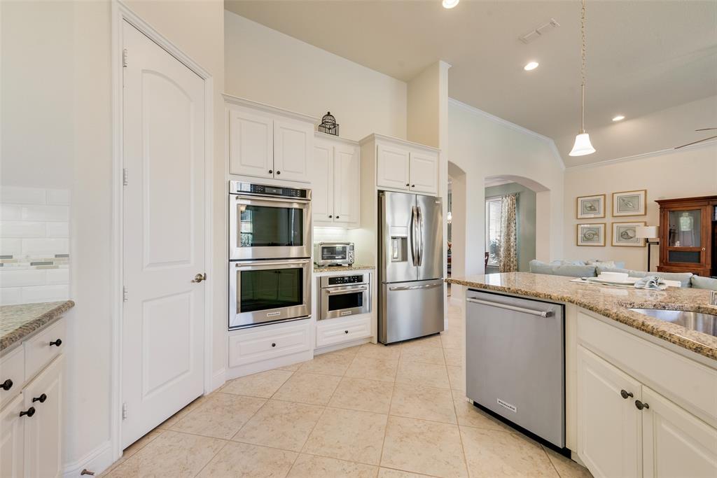 14026 Gutierrez Road Frisco, TX 75035 - Photo 5 of 36 a kitchen with stainless steel appliances a refrigerator and a stove top oven