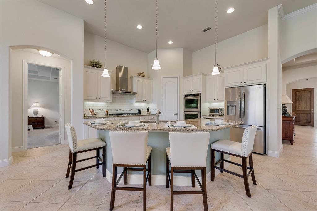 14026 Gutierrez Road Frisco, TX 75035 - Photo 6 of 36 a kitchen with a sink and chairs