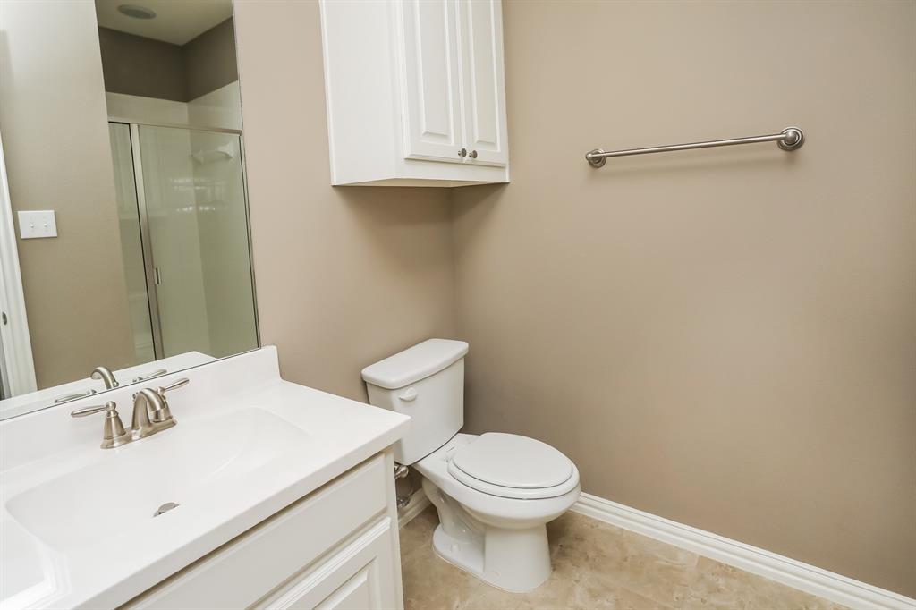 1014 Longhill Way Forney, TX 75126 - Photo 12 of 15 a white toilet sitting next to a bathroom sink