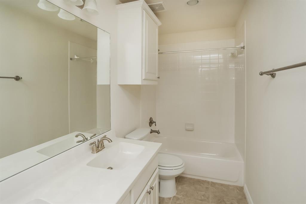 1014 Longhill Way Forney, TX 75126 - Photo 13 of 15 a bathroom with a sink a toilet and shower