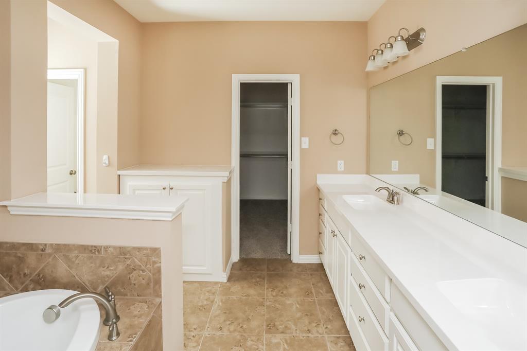 1014 Longhill Way Forney, TX 75126 - Photo 14 of 15 a spacious bathroom with a double vanity sink and a bathtub
