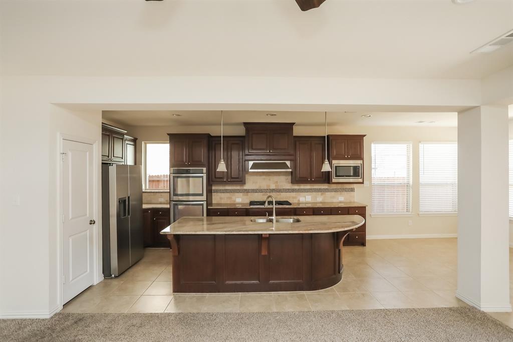 1014 Longhill Way Forney, TX 75126 - Photo 7 of 15 a view of kitchen with stainless steel appliances granite countertop sink