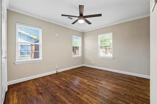 a view of a room with wooden floor and a window