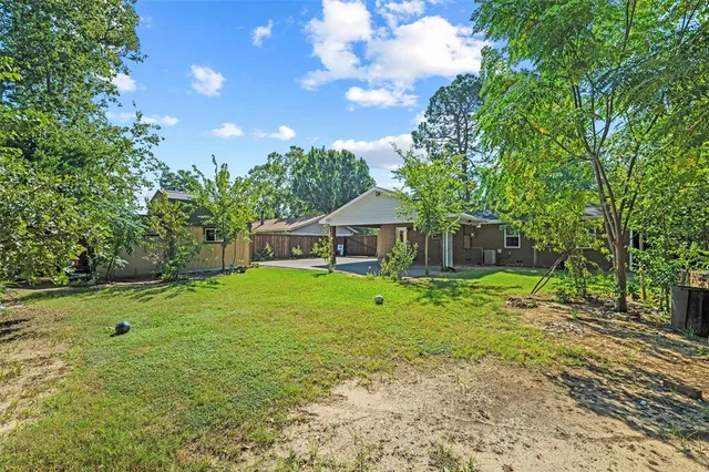 a backyard of a house with table and chairs